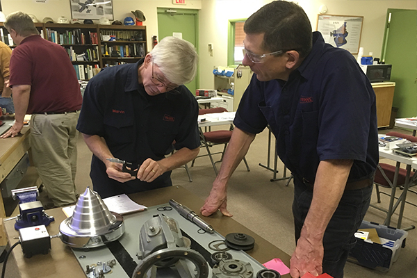 Students checking a pump housing