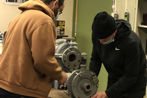 Students rebuilding an older clamped housing for a pump
