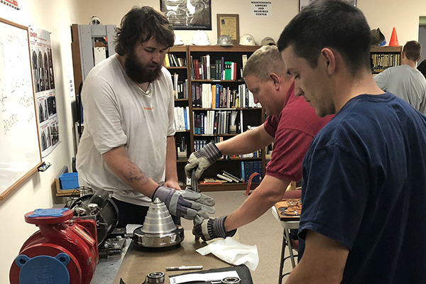 Student installing a bearing on a shaft