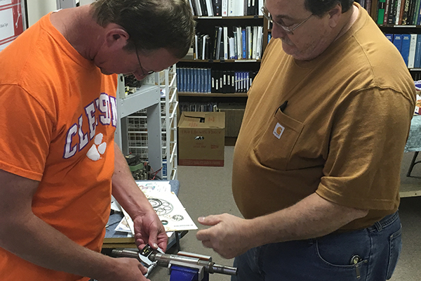 Students finding and replacing the proper bearing on a piece of equipment